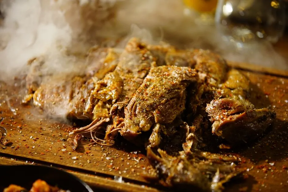 Slow-cooked pulled meat resting on a wooden board, illustrative of dump-and-go cooking